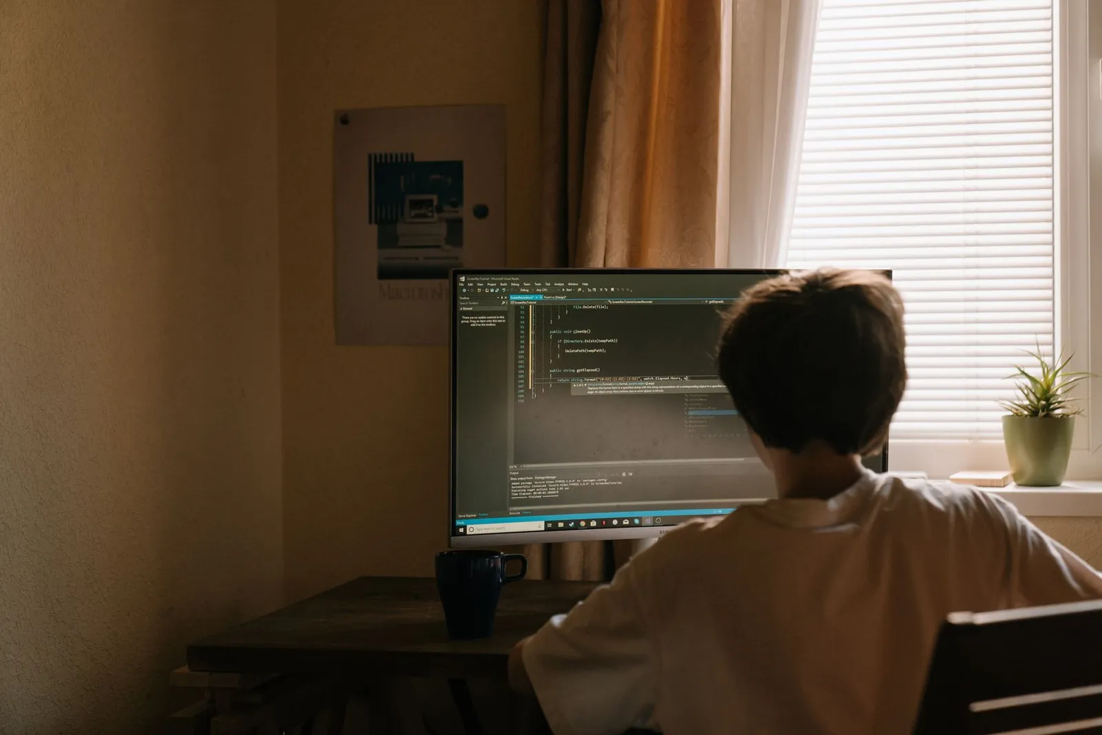 A child writing code on a computer