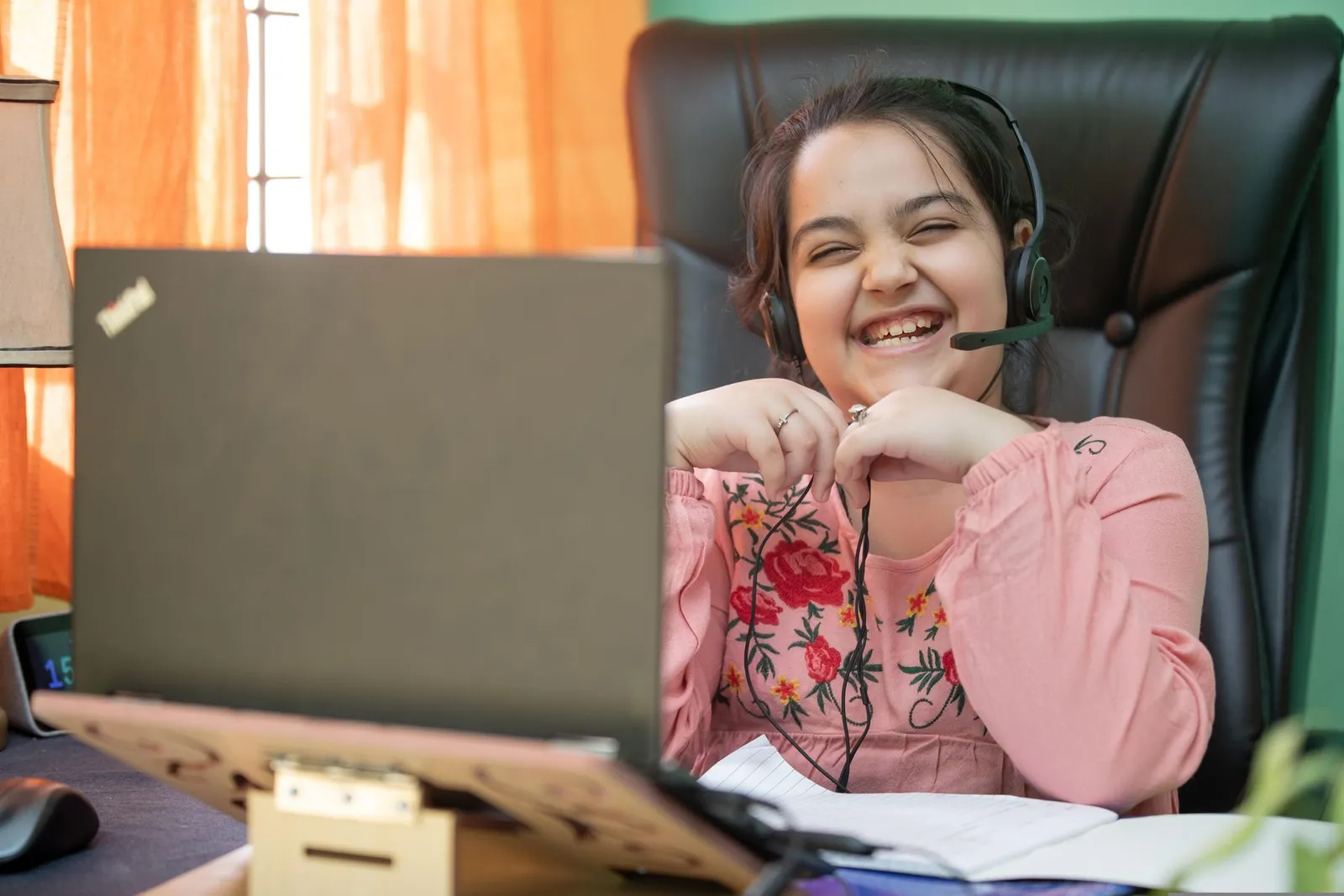 A smiling girl in a live online class